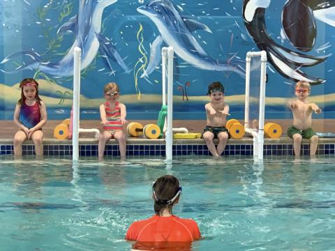 children participating in swim lesson